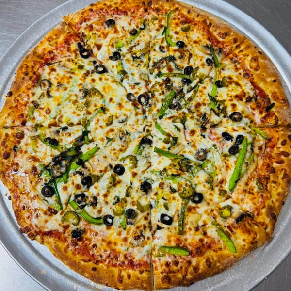A whole AJ'S GRAB N GO pizza, topped with cheese, black olives, and green peppers.