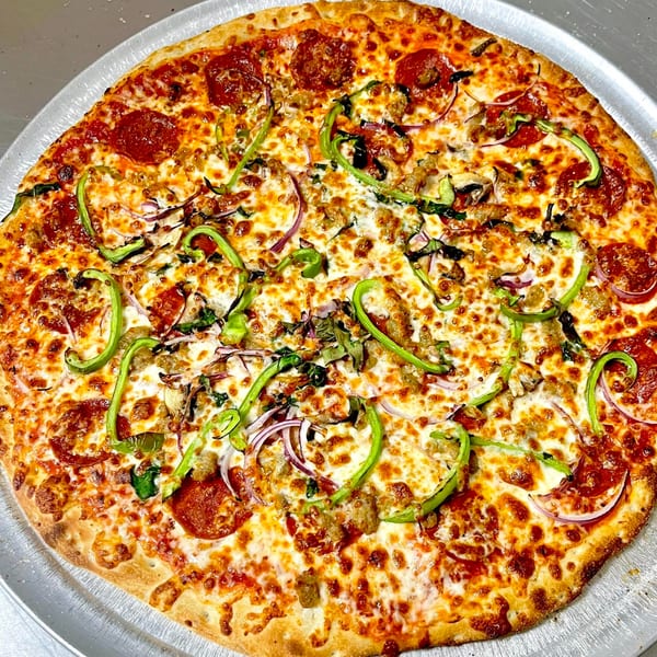 A whole AJ'S GRAB N GO pizza with pepperoni, sausage, green peppers, red onions, and mushrooms.