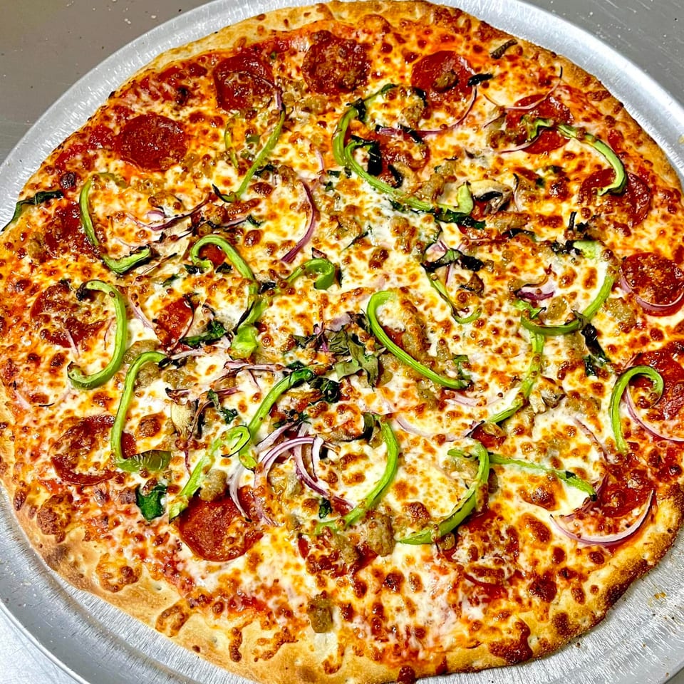 A whole AJ'S GRAB N GO pizza with pepperoni, sausage, green peppers, red onions, and mushrooms.